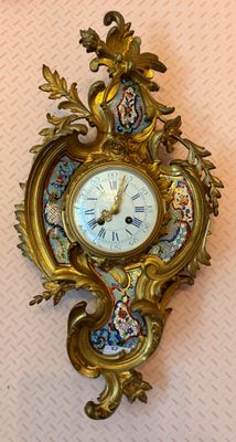 a clock that is on the wall with a bird on it
