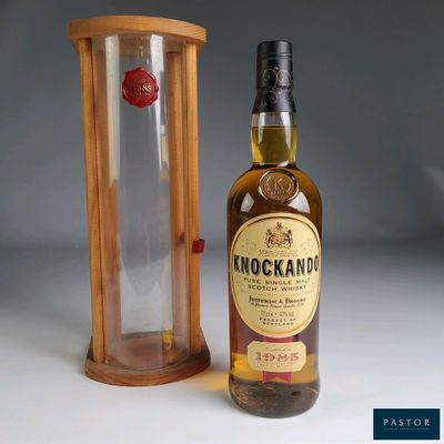 an image of a bottle of whisky next to a wooden case