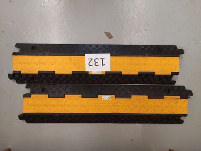 a couple of yellow and black metal plates with a sticker on them