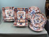 five plates and a bowl sitting on a table