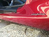 a red car that is parked on the side of the road