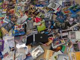 a pile of dvds on the floor next to a remote