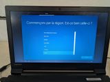 laptop computer sitting on top of a table with a blue screen