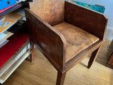 a chair that is sitting in front of a bookshelf