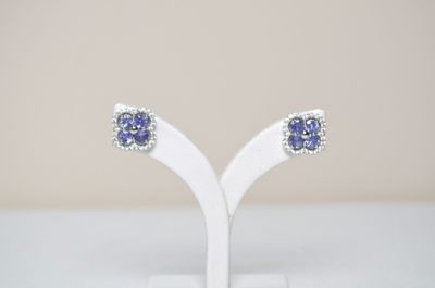 pair of tanzane sapphire and diamond earrings on a white stand