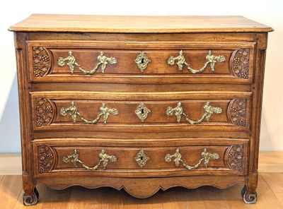 a wooden chest of drawers with ornate carvings on it