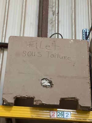 a cardboard box sitting on top of a shelf in a warehouse