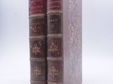 two books sitting on top of each other on a white surface