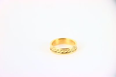 a close up of a gold ring on a white surface