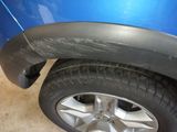 a close up of a tire on a blue car