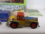 a toy truck with a crane on top of it next to a box