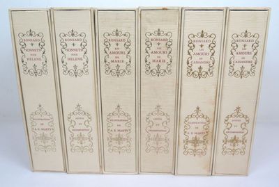 six books in a row on a white surface