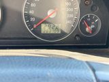 a close up of a car dashboard with a speedometer and gauges