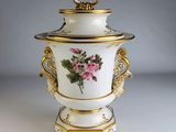 an image of a white vase with pink flowers on it