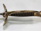 an old sword with a gold handle on a white surface