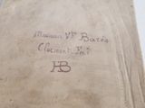 an old book with writing on it sitting on a table