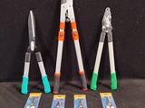four different types of pliers are lined up on a black surface
