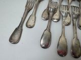 a lot of silver spoons and forks on the table