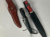 three different types of knives on a white surface with a leather sheath
