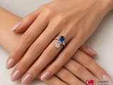 a woman ' s hand with a ring and a ring on it