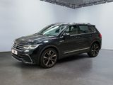 a black volkswagen suv is parked in a large room