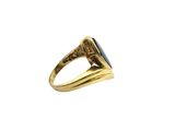 a close up of a gold ring with a blue stone