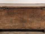 an old wooden chest sitting on top of a hard wood floor