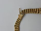 a close up of a gold chain with a lock on it
