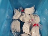 a blue container filled with white plastic spoons and forks