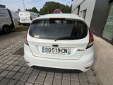 a white car that is parked in front of a building