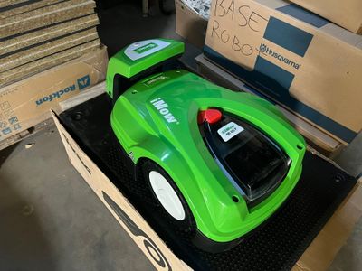 a green toy car sitting on top of a cardboard box