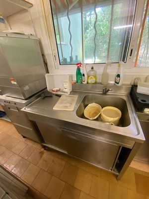 a kitchen with a sink, stove, and a dishwasher