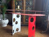 a red and white table that has holes in it