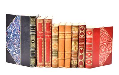 many books lined up in a row on a white surface