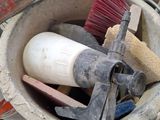 a bucket full of tools that are sitting on a table