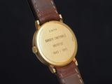 a close up of a wrist watch with a brown leather strap