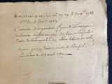 an old piece of paper with writing on it sitting on top of a table