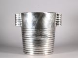 a silver vase that is sitting on a table