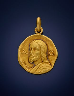 a close up of a gold coin with a jesus face on it