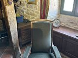 a chair that is sitting in a room by a window