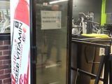 a vending machine with a sign on the front of it