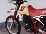 a red and white yamaha motorcycle parked in a garage