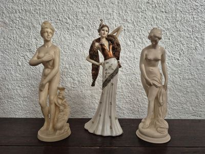 three statues that are sitting on a table