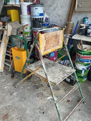 a chair that is sitting next to a stack of buckets