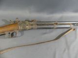 an old gun with a wooden handle on a white background