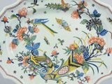 a plate with a bird and flowers design on it