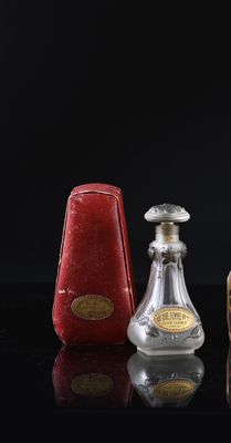 three bottles of perfume sitting on a table with a black background