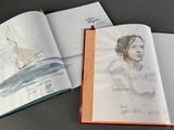 a book with a drawing of a man and a boat