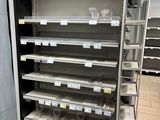 many empty shelves in a store with food items on them