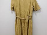 a yellow dress hanging on a hanger in a white room